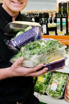 Man buying vegetables in a supermarket