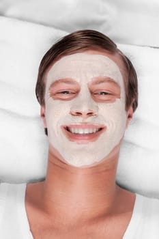 Man with face pack on his face