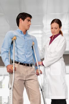 Doctor assisting a patient to walk