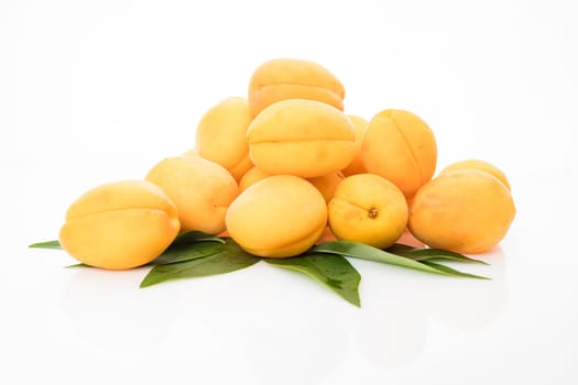 Apricot fruit with leaf  isolated on white background