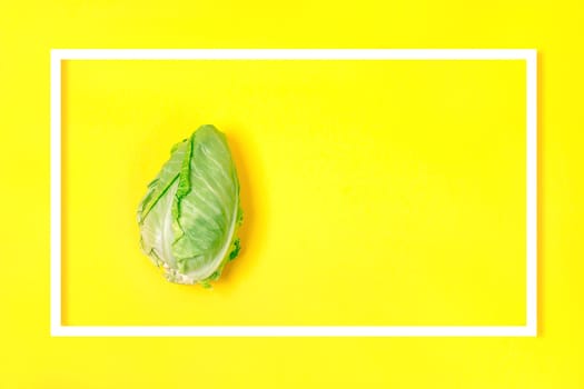 Minimal flat lay concept. Banner with chinese cabbage in a frame on Illuminating background. Design element. Full depth of field.