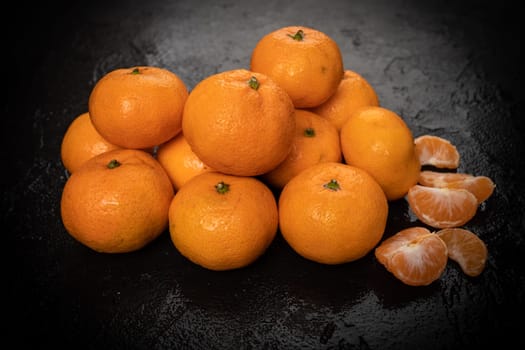 Mandarines, tangerine, clementine on black background