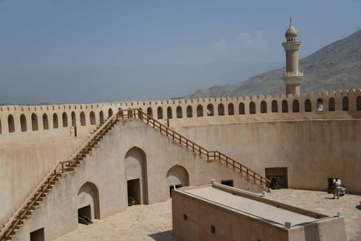 The large historical fortress Fort Nizwa is located on the edge of the Hajar Mountains in the oasis city in Oman on the Arabian Peninsula and is a tourist attraction.