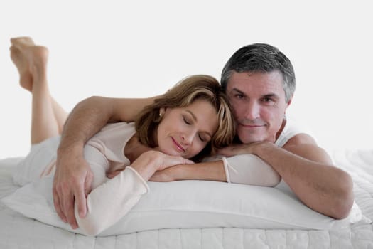 Couple lying on the bed and smiling