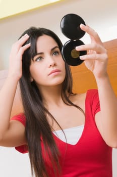 Close_up of a young woman adjusting her hair
