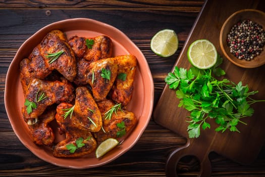 Hot and Spicey Buffalo Chicken Wings with ingredients on wooden background