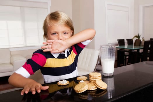Girl having cookies and milk