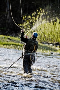 Rear view of a man fishing