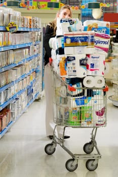 Woman pushing a shopping cart in a supermarket