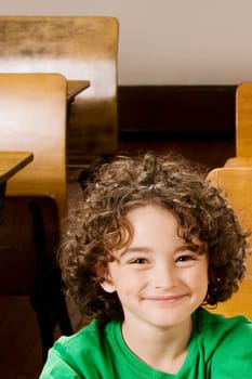 Portrait of a schoolboy smiling in a classroom