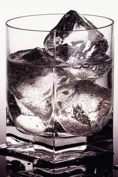 Close_up of a glass of wine with ice cubes