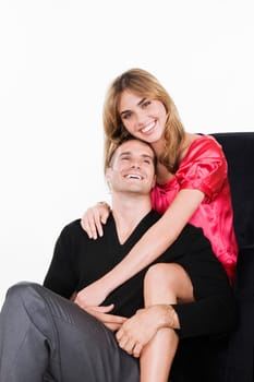 Portrait of a young woman embracing a young man from behind and smiling
