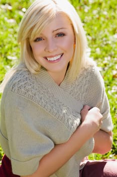 Portrait of a young woman smiling in a park