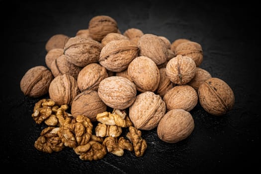 Walnut on over black slate stone background