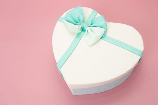 Heart Gift box with ribbon on pink surface
