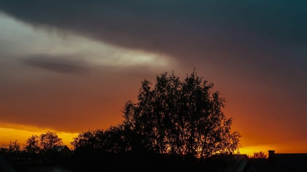 Strong orange fire sky at the sunset with clouds from a storm