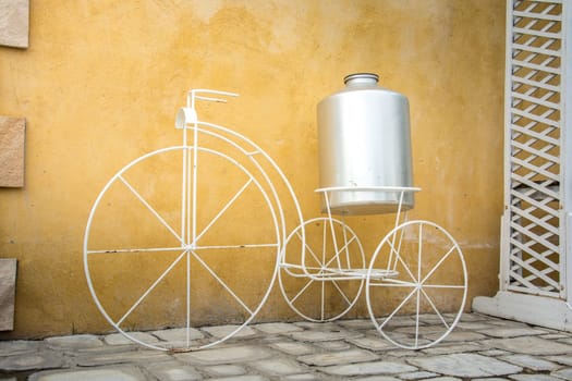 light on white decor bicycle on the rock wall background.
