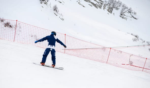 Sochi  Russia - January 02  2021: Snowboarder go downhill at the Krasnaya Polyana ski resort