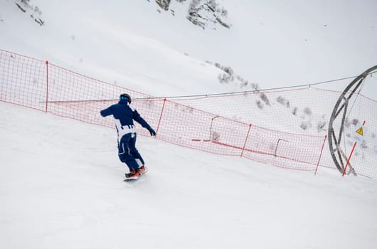 Sochi  Russia - January 02  2021: Snowboarder go downhill at the Krasnaya Polyana ski resort