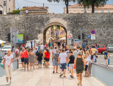 Zadar, Croatia, July 2019 Tourists visiting beautiful, narrow streets of the old town of Zaton with ancient, early Romanesque architecture
