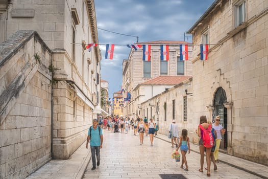 Zadar, Croatia, July 2019 Tourists visiting beautiful, narrow streets of the old town of Zaton with ancient, early Romanesque architecture