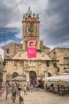 Zadar, Croatia, July 2019 St. Lawrence Church in old town square with tourists relaxing in restaurant and beer garden