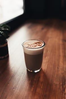 Cup of coffee at table in cafe near window. Blurred background. High quality photo