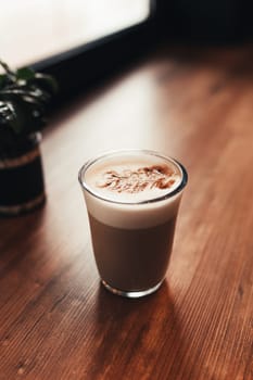Cup of coffee at table in cafe near window. Blurred background. High quality photo
