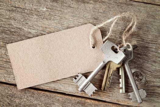 Bunch of  keys with blank tag on the wooden background