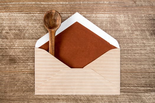 Mail envelope with a small wooden spoon