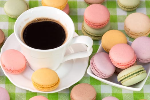 Delicious french macaroons with cup of black coffee