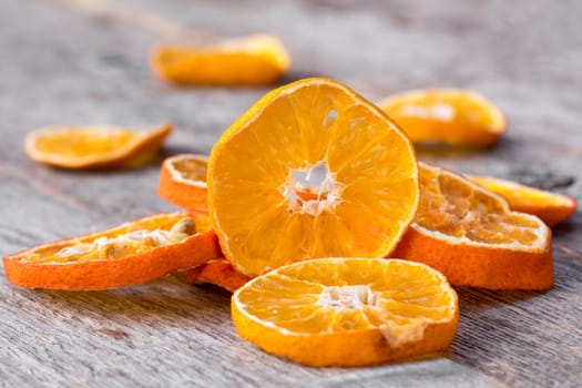 Slices of dried orange on the wooden background