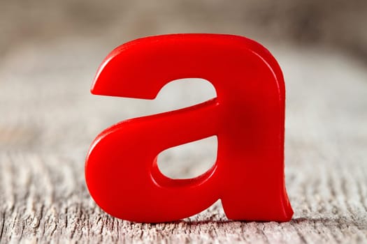 First letter of alphabet on the wooden background