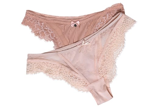 Underwear woman isolated. Close-up of two luxurious elegant sexy beige lacy thongs panties isolated on a white background. Underwear fashion. Front view.
