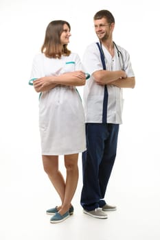 A man doctor and a girl nurse stand with their backs to each other and looked at each other happily
