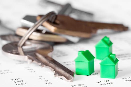 Three miniature houses and bunch of keys. Real estate concept.