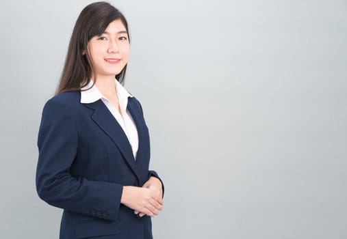 Portrait of asian business woman standing isolated on gray background