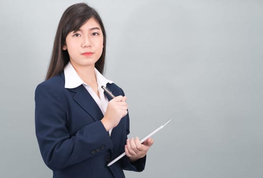 Woman in suit using computer digital tablet isolate on gray background