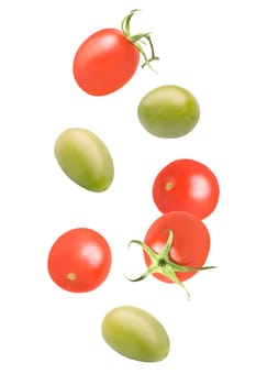 Isolated vegetables. Seven mixed tomatoes and green olives falling down with clipping path as package design element. Full depth of field. Food levitation concept.