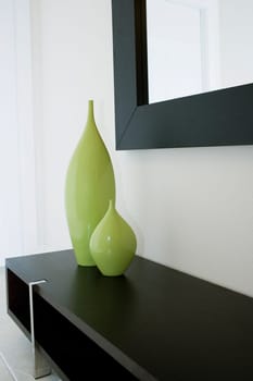 Two decorative urns on a cabinet