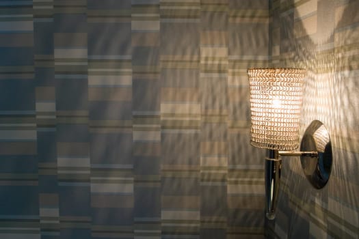 Close-up of an illuminated lamp on a wall