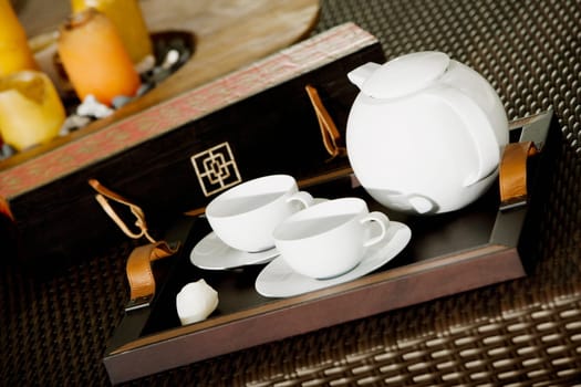 Close-up of a teapot with teacups on a serving tray
