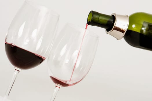 Close-up of wine being poured into wine glasses