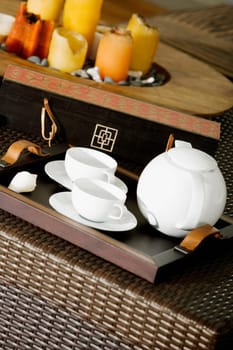 Close-up of a serving tray and candles on a place mat
