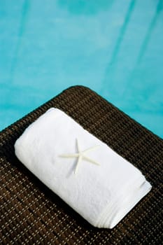 High angle view of a starfish with a towel on a lounge chair at the poolside