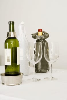 Wine bottles and two wine glasses on a dining table
