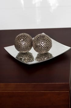 Close-up of two decorative balls in a tray
