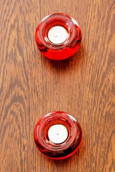 High angle view of two candles in candlestick holders on a table