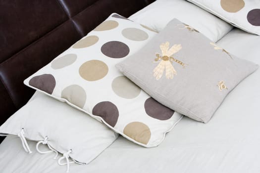 Close-up of cushions and pillows on the bed
