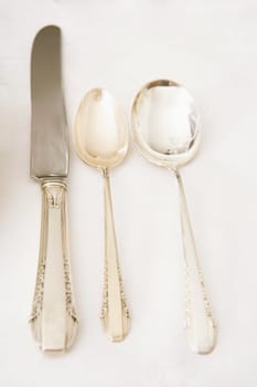 Table knife with two spoons on a dining table